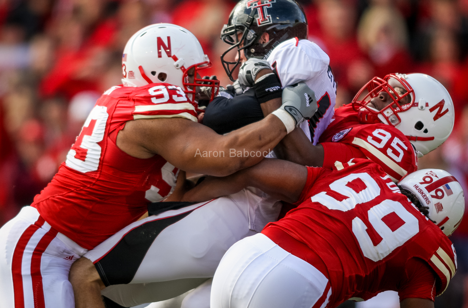 Ndamukong Suh (93), Pierre Allen (95) and Barry Turner (99) team up n a tackle against Texas Tech on Oct. 17, 2009. © Aaron Babcock