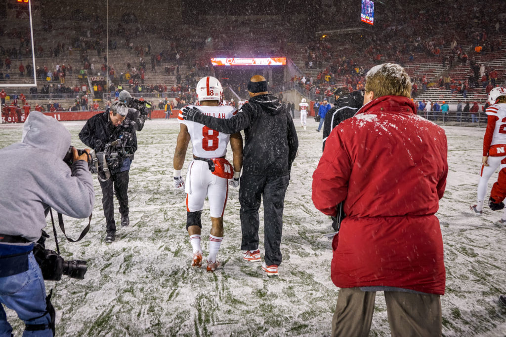 football player leaving field in snow