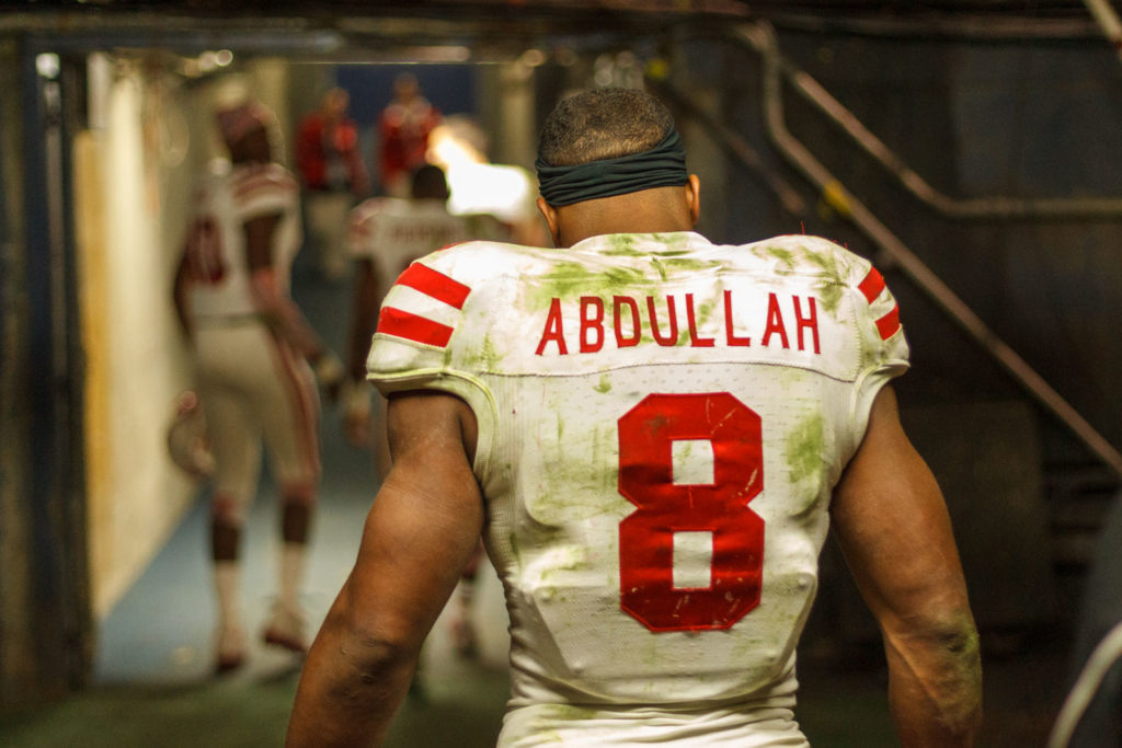 football players walking down tunnel